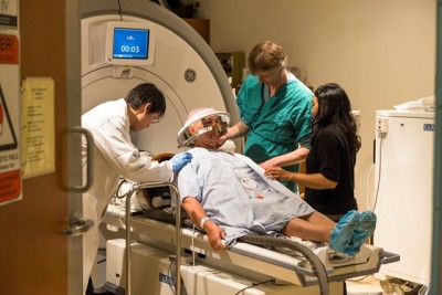 Bonny Hall being prepped for the focused ultrasound procedure. A head frame was screwed to her skull and she laid down on the MRI bed where the head frame was connected to a “helmet” that is part of Insightec’s Exablate Neuro System.